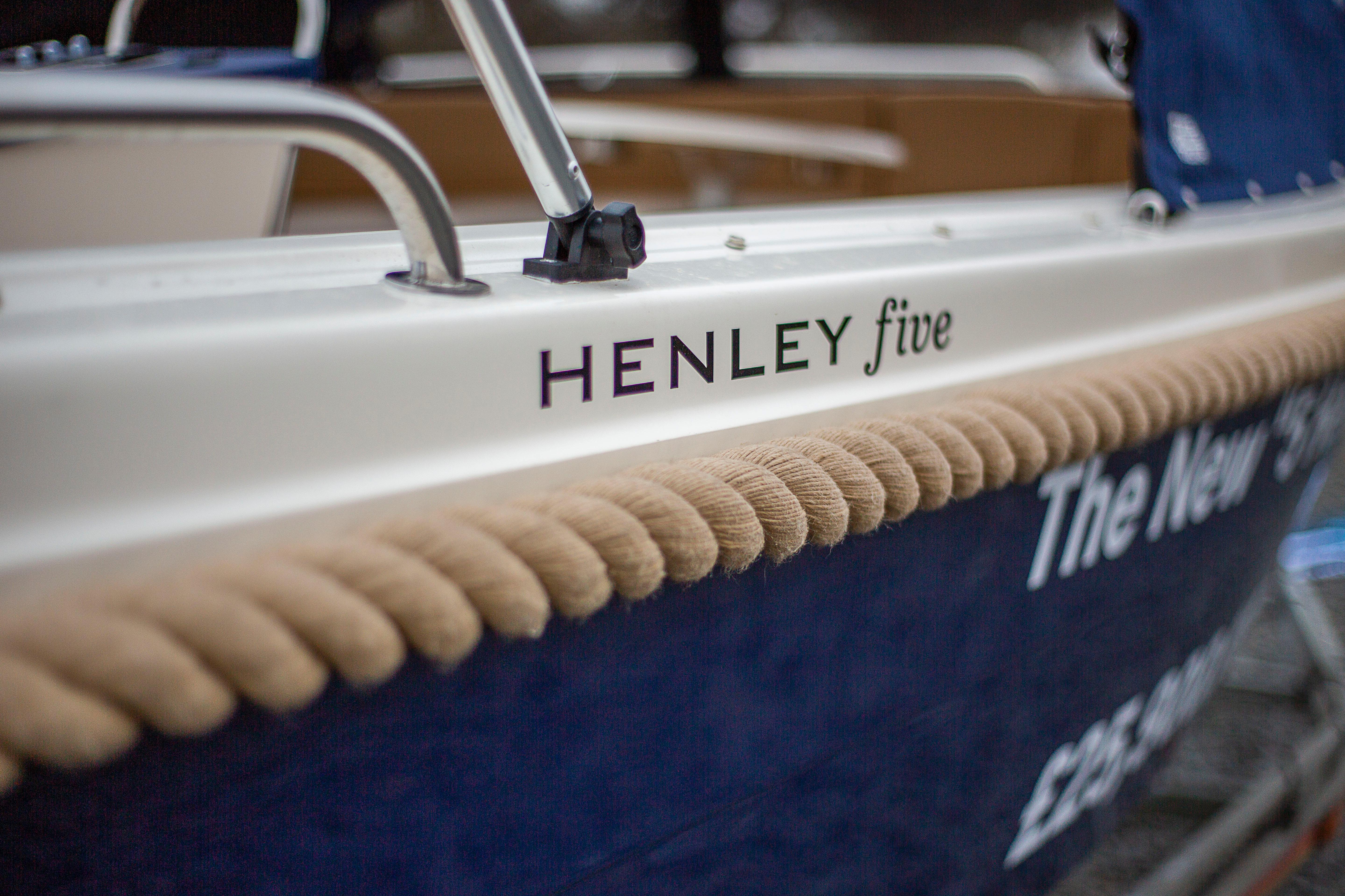 Henley Five nameplate and traditional rope fender on the blue hull